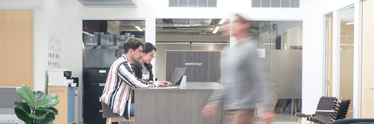 business people in an office looking at a laptop computer