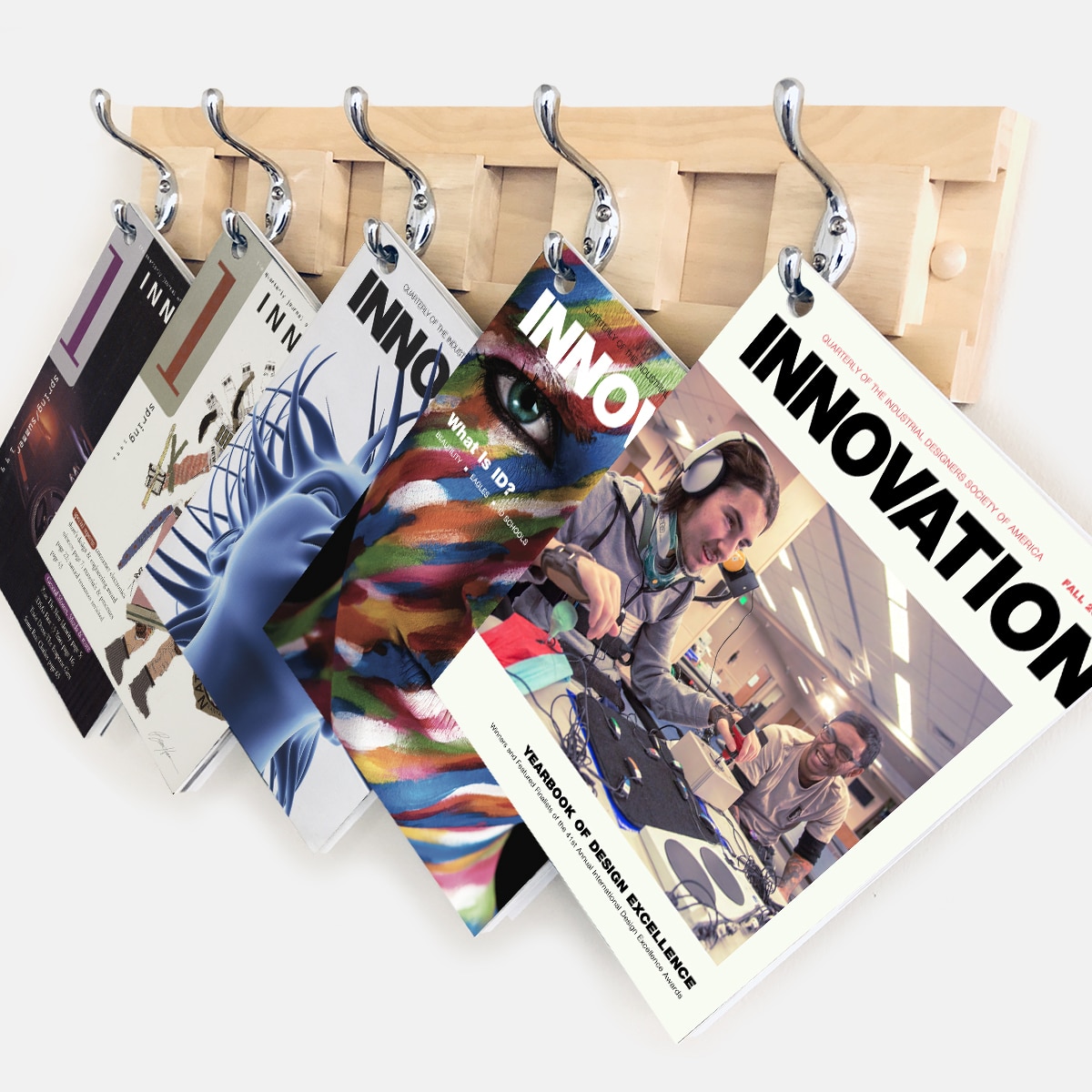 A collection of INNOVATION magazines hangs on a rack