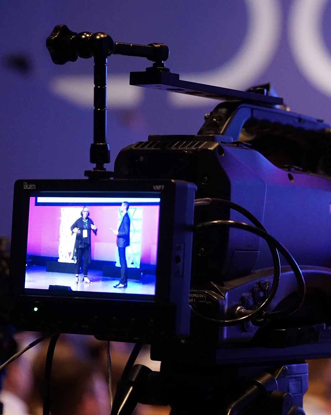A video camera recording a stage presentation