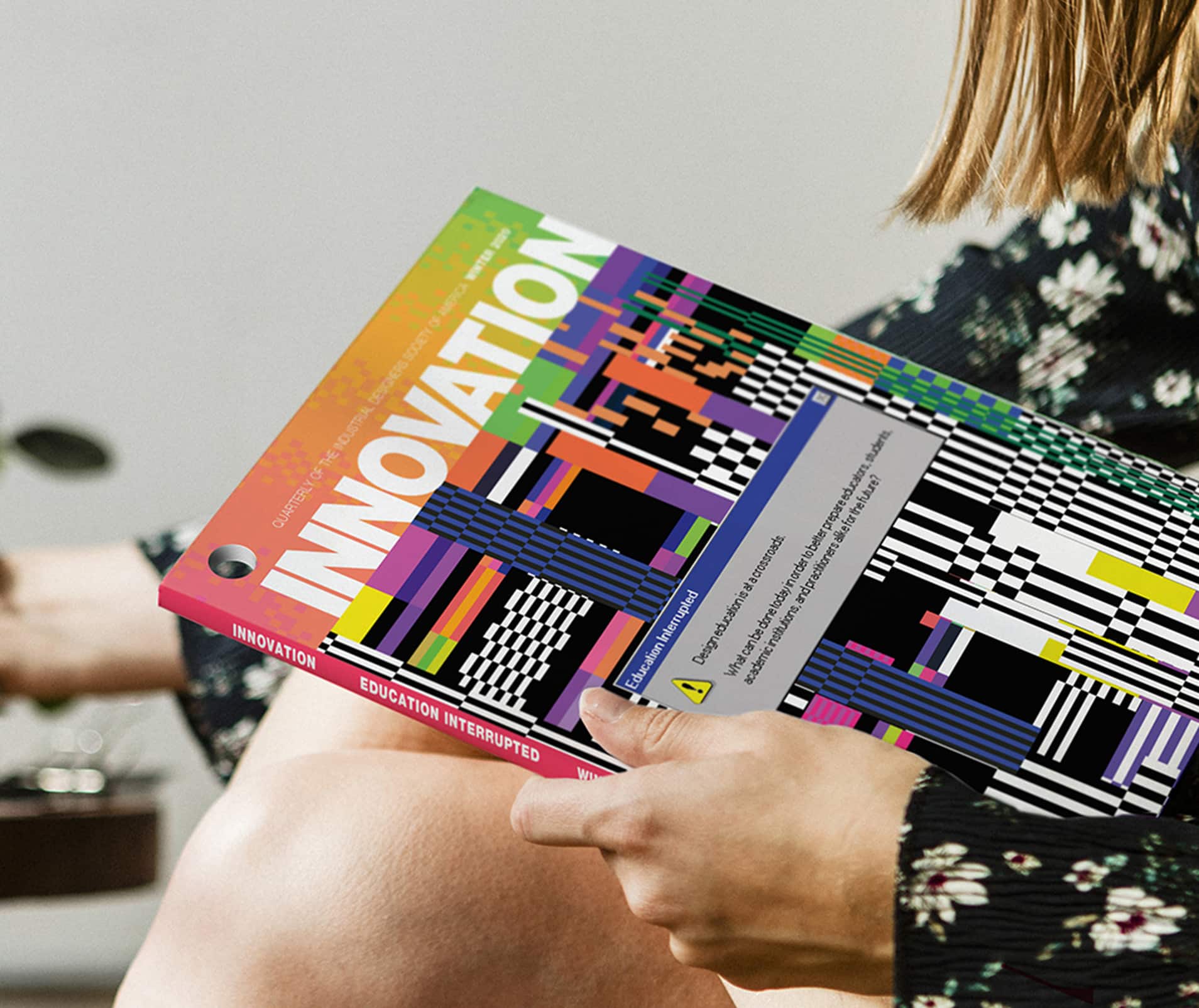 A woman reads INNOVATION magazine