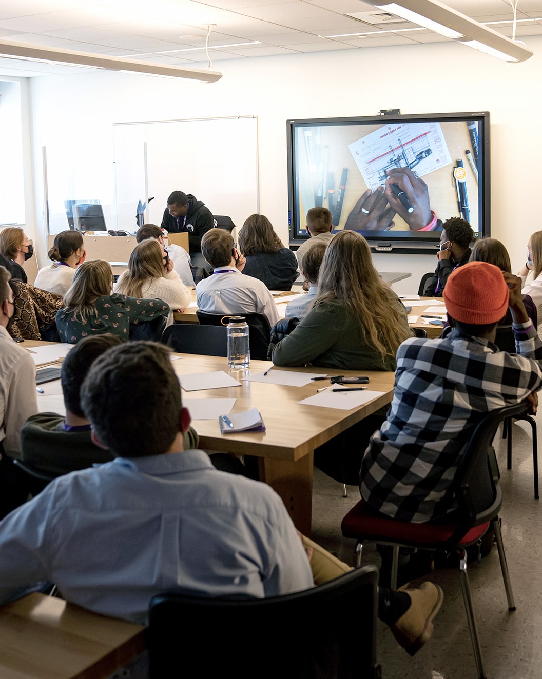 Design students watch a sketching demonstration