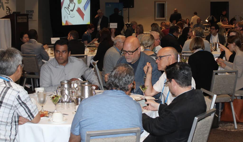 guests converse at the 2015 education symposium