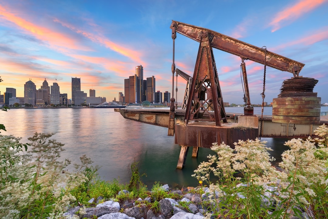 The Detroit, Michigan, USA skyline as seen from across the Detroit River in Windsor, Ontario, Canada at dusk.